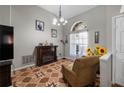 Cozy living room featuring decorative floors, electric fireplace, and a large window for natural light at 4428 Winding River Drive, Valrico, FL 33596
