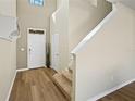 Inviting foyer with wood-look floors, a coat rack and a staircase leading to the upper level at 4502 Banyan Tree Pl, Riverview, FL 33578