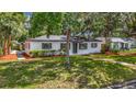 Cozy home featuring a well-maintained lawn and mature landscaping, great curb appeal at 4202 W Bay Vista Ave, Tampa, FL 33611