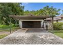 The large two-car carport features a brick paver drive leading up to it at 4401 W Sam Allen Rd, Plant City, FL 33565