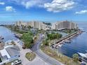 Panoramic aerial view of waterfront condos, boat docks, tennis courts, and lush landscaping at 6009 Sea Ranch Dr # 203, Hudson, FL 34667