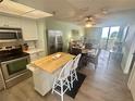 Open floor plan with stainless steel appliances and ample storage space near the dining area at 6009 Sea Ranch Dr # 203, Hudson, FL 34667