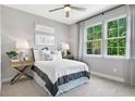 Comfortable bedroom featuring neutral tones, a ceiling fan, and plenty of natural light at 9293 Players Dr, Weeki Wachee, FL 34613