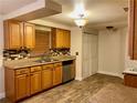 Kitchen with wood cabinets and tile floor at 2718 Midtimes Dr, Tampa, FL 33618