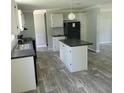 Modern kitchen with island, stainless steel appliances, and light gray cabinets at 2459 Ayerswood Dr, Brooksville, FL 34604