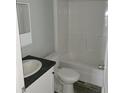 Simple bathroom with a shower/tub combo and dark countertop at 2459 Ayerswood Dr, Brooksville, FL 34604