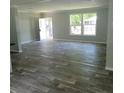 Open living room with gray flooring and lots of natural light at 2459 Ayerswood Dr, Brooksville, FL 34604