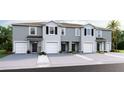 Charming exterior of townhomes featuring individual garages and well-kept landscaping at 5108 Captain Davis Dr, Wimauma, FL 33598