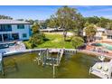 Expansive waterfront lot featuring a boat dock, lush greenery, and serene water views at 2417 S Dundee St, Tampa, FL 33629