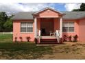 Pink house with front porch and columns at 1430 N Kingsway Rd, Seffner, FL 33584