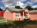 Pink house with front porch and columns at 1430 N Kingsway Rd, Seffner, FL 33584