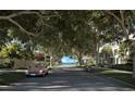 Luxury community with tree-lined streets, waterfront views, and classic car at 3015 S Ysabella Ave # 1002, Tampa, FL 33629