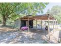 Rustic storage shed with covered parking area for vehicles and equipment at 3736 Lado Dr, Wesley Chapel, FL 33543