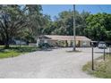 Ranch home on a spacious lot with a gravel driveway at 3736 Lado Dr, Wesley Chapel, FL 33543