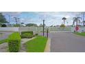 Gated entrance to a residential community featuring lush landscaping and well-maintained grounds at 4329 Tahitian Gardens Cir # B, Holiday, FL 34691