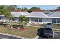 Aerial view of a well-maintained condo with a gray truck parked in front and a neatly landscaped yard at 4329 Tahitian Gardens Cir # B, Holiday, FL 34691