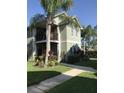 Two-story house with balcony, landscaping, and palm trees at 4009 Foxtail Palm Ct # 2, Tampa, FL 33624