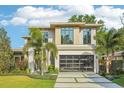 Beautiful home featuring a sleek design, large windows, glass garage door and well manicured lawn at 1630 Douglas Ave, Dunedin, FL 34698