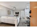 Living room with white couch, TV, and modern decor at 8901 Blind Pass Rd # 228, St Pete Beach, FL 33706