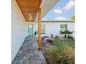 Inviting entrance with a covered walkway, custom door, and carefully landscaped area at 15810 2Nd E St, Redington Beach, FL 33708