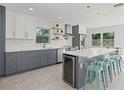 Modern kitchen with stainless steel appliances, white subway tile, and a large center island at 15810 2Nd E St, Redington Beach, FL 33708