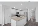Modern kitchen with stainless steel appliances and an island with granite countertops at 5389 Ulysses St, Port Charlotte, FL 33981