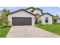 New home exterior with paver driveway and landscaping at 5413 Dayton Ln, Port Charlotte, FL 33981