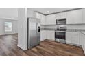 Modern kitchen with stainless steel appliances and wood flooring at 5413 Dayton Ln, Port Charlotte, FL 33981