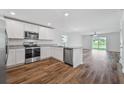 Open concept kitchen with stainless steel appliances and island at 5413 Dayton Ln, Port Charlotte, FL 33981