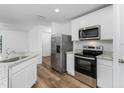 Modern kitchen with white cabinets, stainless steel appliances, and granite countertops at 12157 Shellnut Ave, Port Charlotte, FL 33981