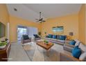 Bright living room with high ceilings, neutral furniture, ceiling fan and sliding glass doors at 2220 Kings Palace Dr, Riverview, FL 33578