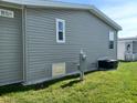 Gray vinyl-sided home with a partial view of the backyard at 2140 Gondola Dr, Sarasota, FL 34238