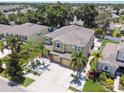 Two-story house with a landscaped yard and a two-car garage, viewed from above at 10413 Hampton Meadow Way, Riverview, FL 33578