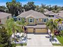 Two-story house with three car garage and landscaped yard at 10413 Hampton Meadow Way, Riverview, FL 33578
