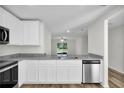 Modern kitchen featuring granite countertops and stainless steel appliances at 5952 Gillot Blvd, Port Charlotte, FL 33981