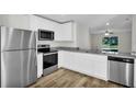 Modern kitchen with stainless steel appliances and white shaker cabinets at 5952 Gillot Blvd, Port Charlotte, FL 33981