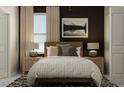 Bright bedroom with a queen bed, nightstands, and a large window at 10439 Lavender Aster Trl, San Antonio, FL 33576