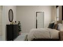 Cozy bedroom with a full bed, dresser, and a view of another room at 10439 Lavender Aster Trl, San Antonio, FL 33576