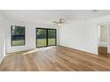 Bright bedroom with wood-look floors and sliding glass doors at 13315 Flaherty Ave, Port Charlotte, FL 33981