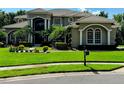 A luxurious home with a well-kept lawn and manicured landscaping, complemented by an old-fashioned mailbox at 5016 Givendale Ln, Tampa, FL 33647