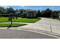 Beautiful home with a well-manicured lawn and a driveway combining concrete and decorative brick accents at 5016 Givendale Ln, Tampa, FL 33647
