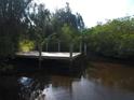 Wooden dock on calm waterway with lush vegetation at 6109 Adams St, Gibsonton, FL 33534