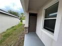 Front door entry with sidelight and stone accents at 8115 Alamosa Wood Ave, Ruskin, FL 33573