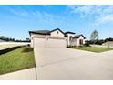 Two-car garage and landscaped yard at 839 Tierra Dr, Spring Hill, FL 34609