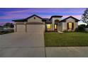 Two-car garage and landscaped yard at 839 Tierra Dr, Spring Hill, FL 34609