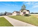 Single-story house with two-car garage and landscaped lawn at 839 Tierra Dr, Spring Hill, FL 34609