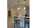 Kitchen with breakfast bar and view into the dining area at 12831 Oriago St, Venice, FL 34293