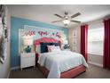 Charming bedroom with a coral headboard and a whimsical wall decal at 32112 Powderpuff Mimosa Dr, San Antonio, FL 33576