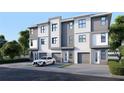 Modern three-unit building with attached garages and landscaping at 3469 Desert Trunk Ct, Tampa, FL 33614