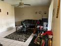 Living room with sectional sofa, coffee table, and floor lamp at 302 E Whitehall Ct # 111, Tampa, FL 33604